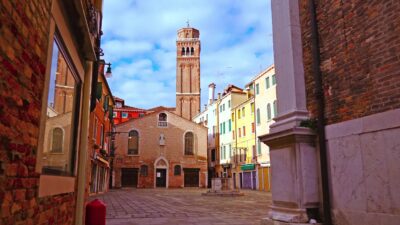 Venice ancient tower among historical houses