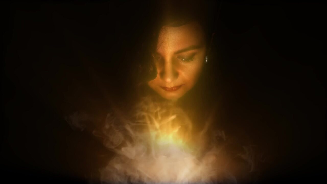 Woman holds in the hands radius of light