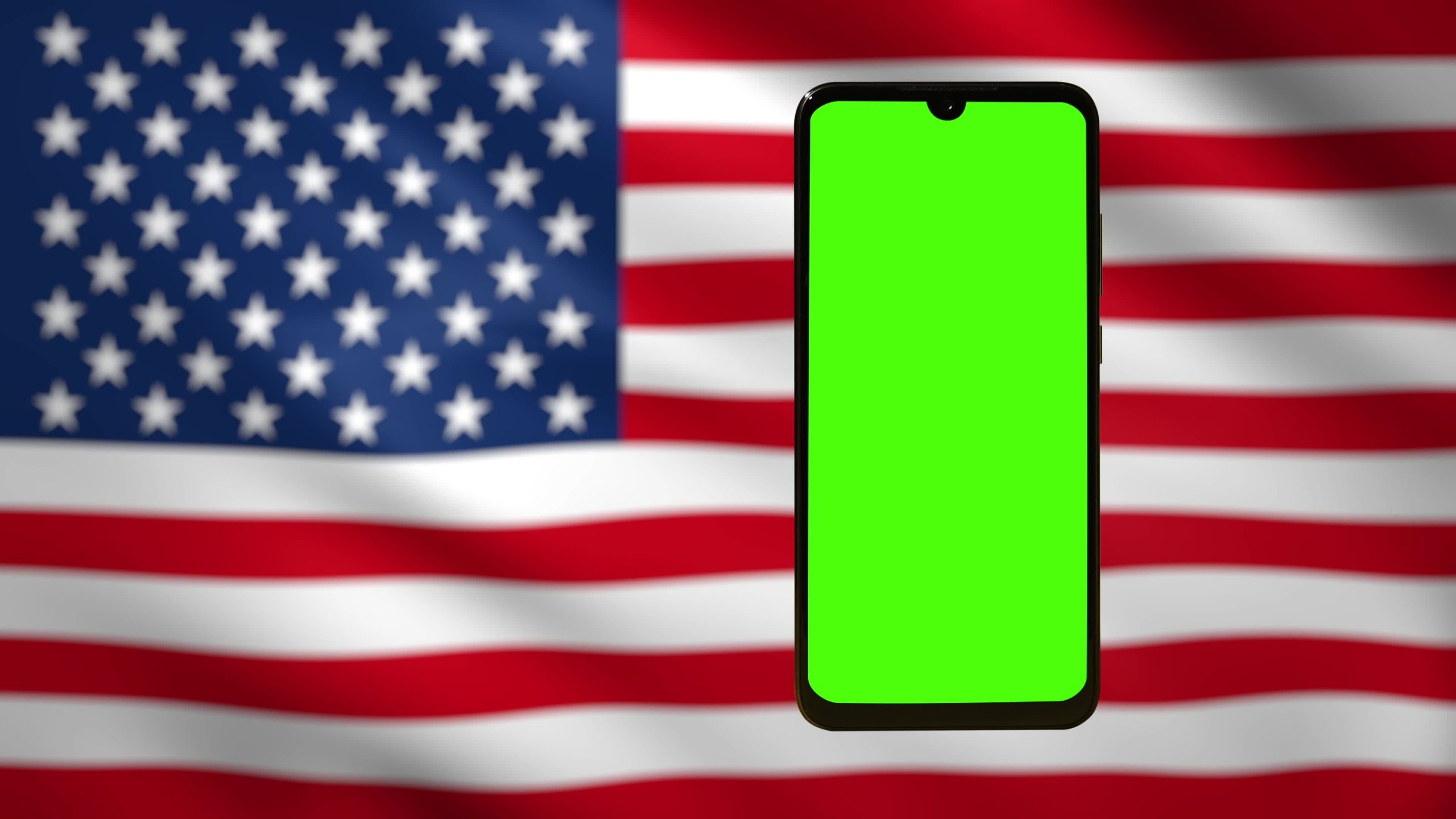 Smartphone with green screen with American flag in the background