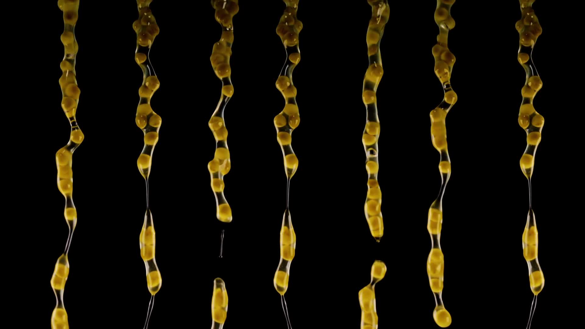 Streams of wet peas falling in slow motion