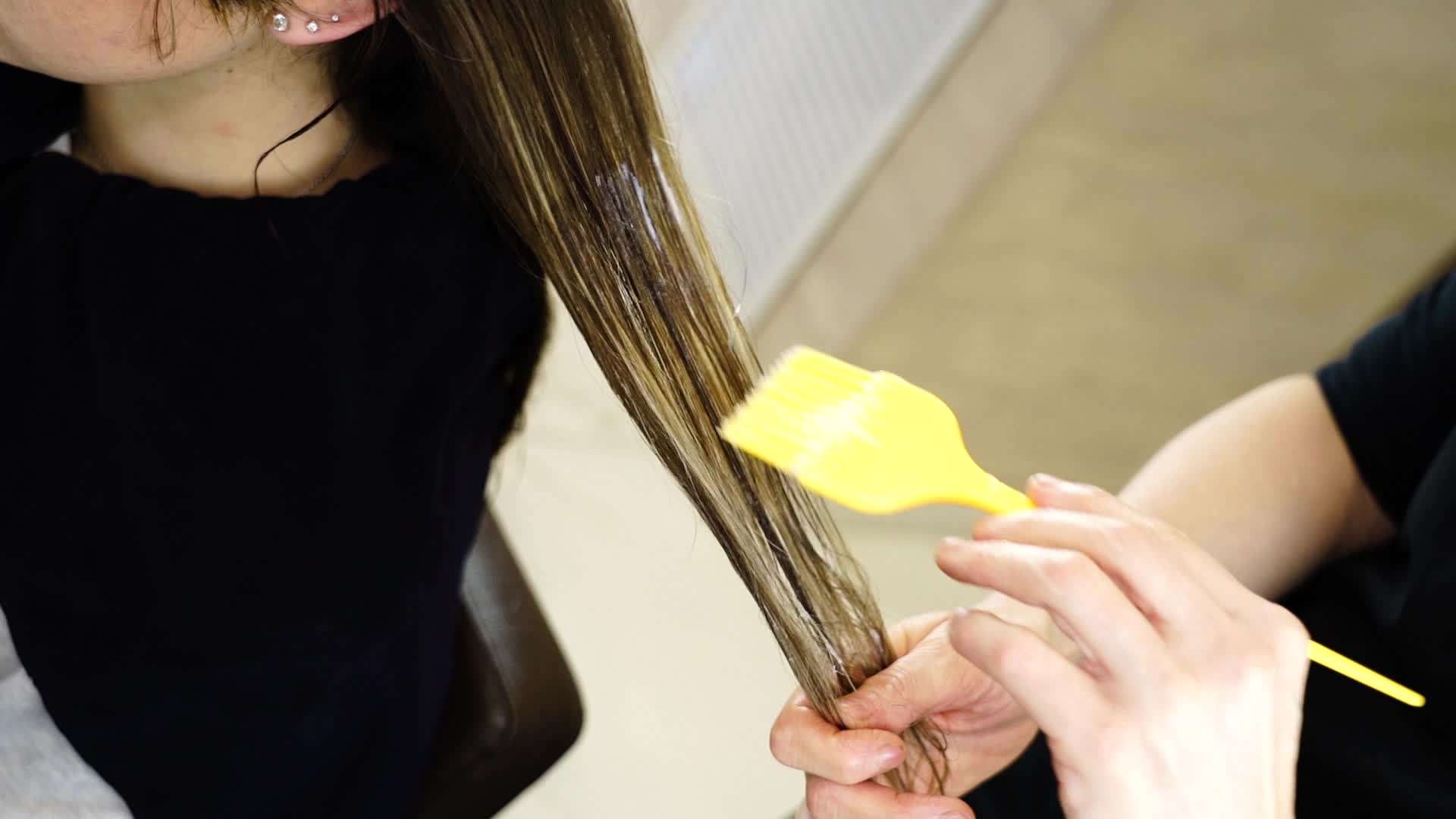 Fixer is applied to the woman’s hair