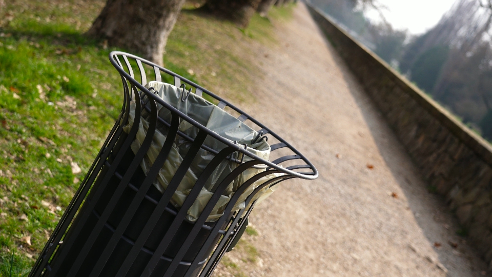 Stylish cylinder metal garbage bin in local city park