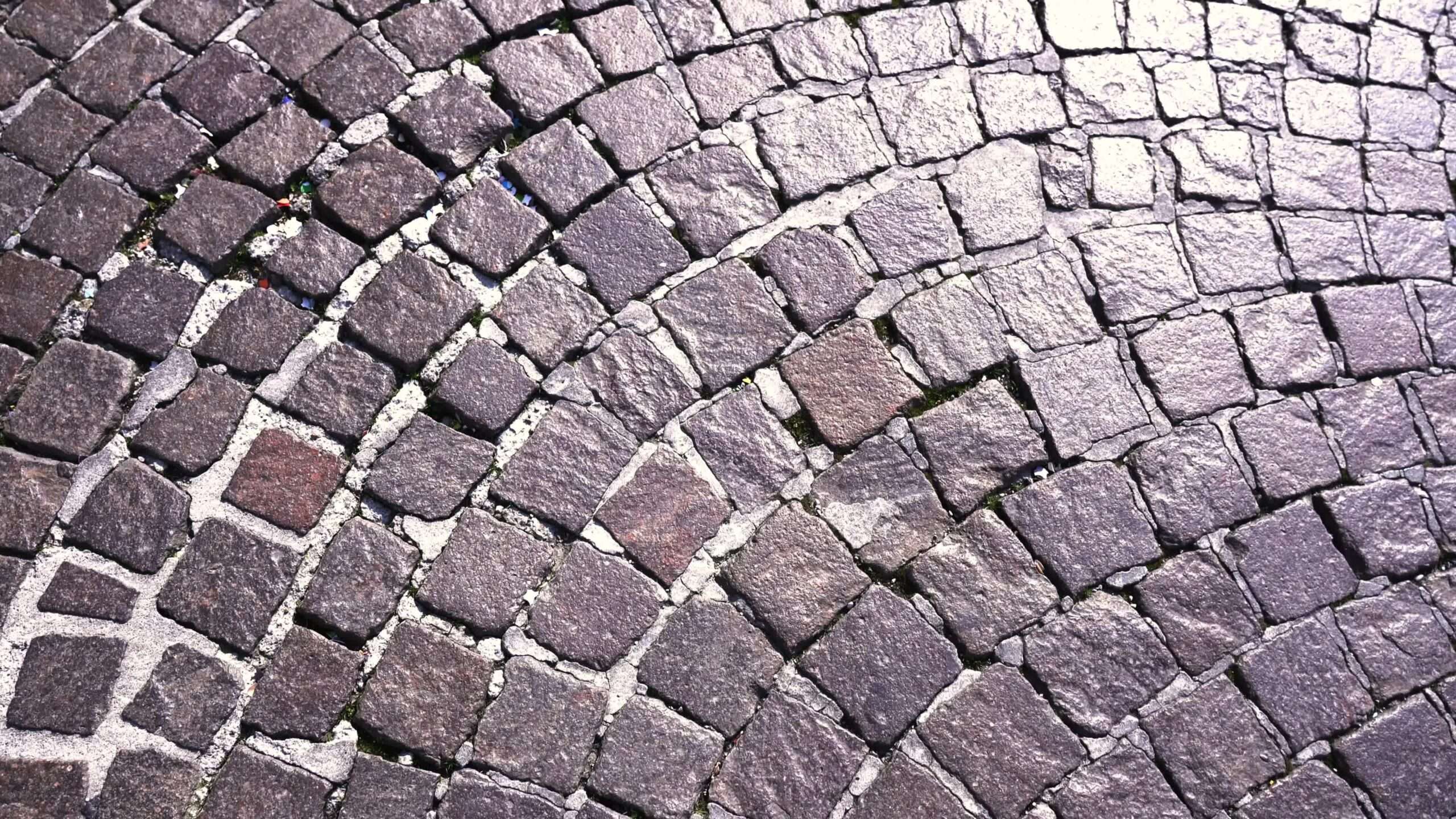 Old stone road in granite reflecting sunlight