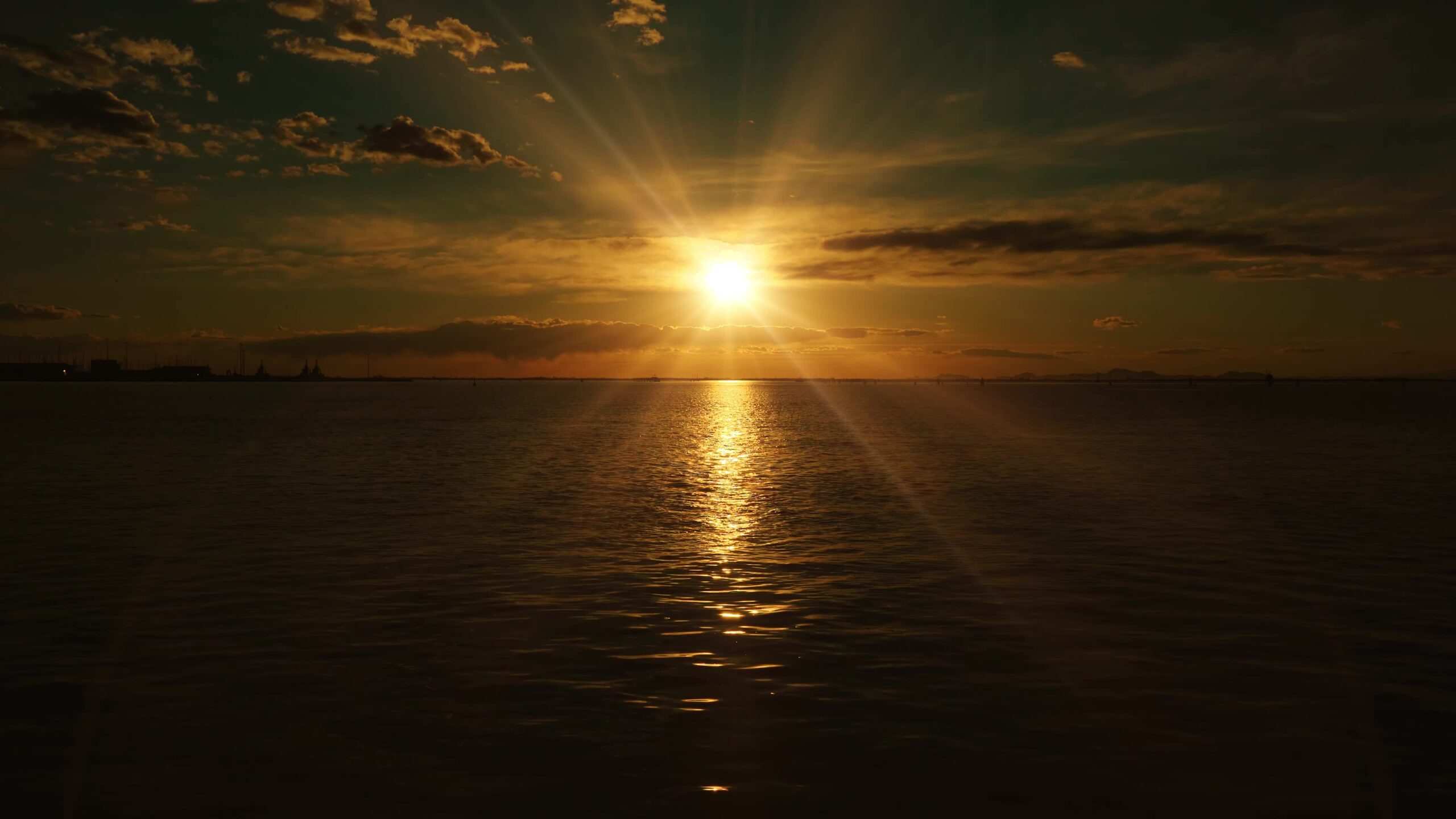 Sole illumina la laguna veneziana scura increspatura dell’acqua