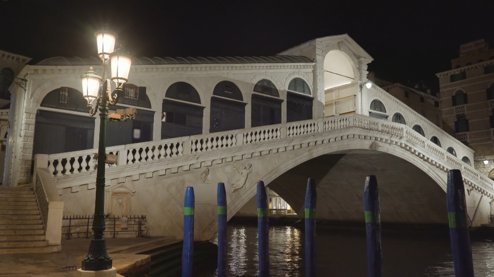 Illuminated arch Rialto bridge over Grand Canal at night