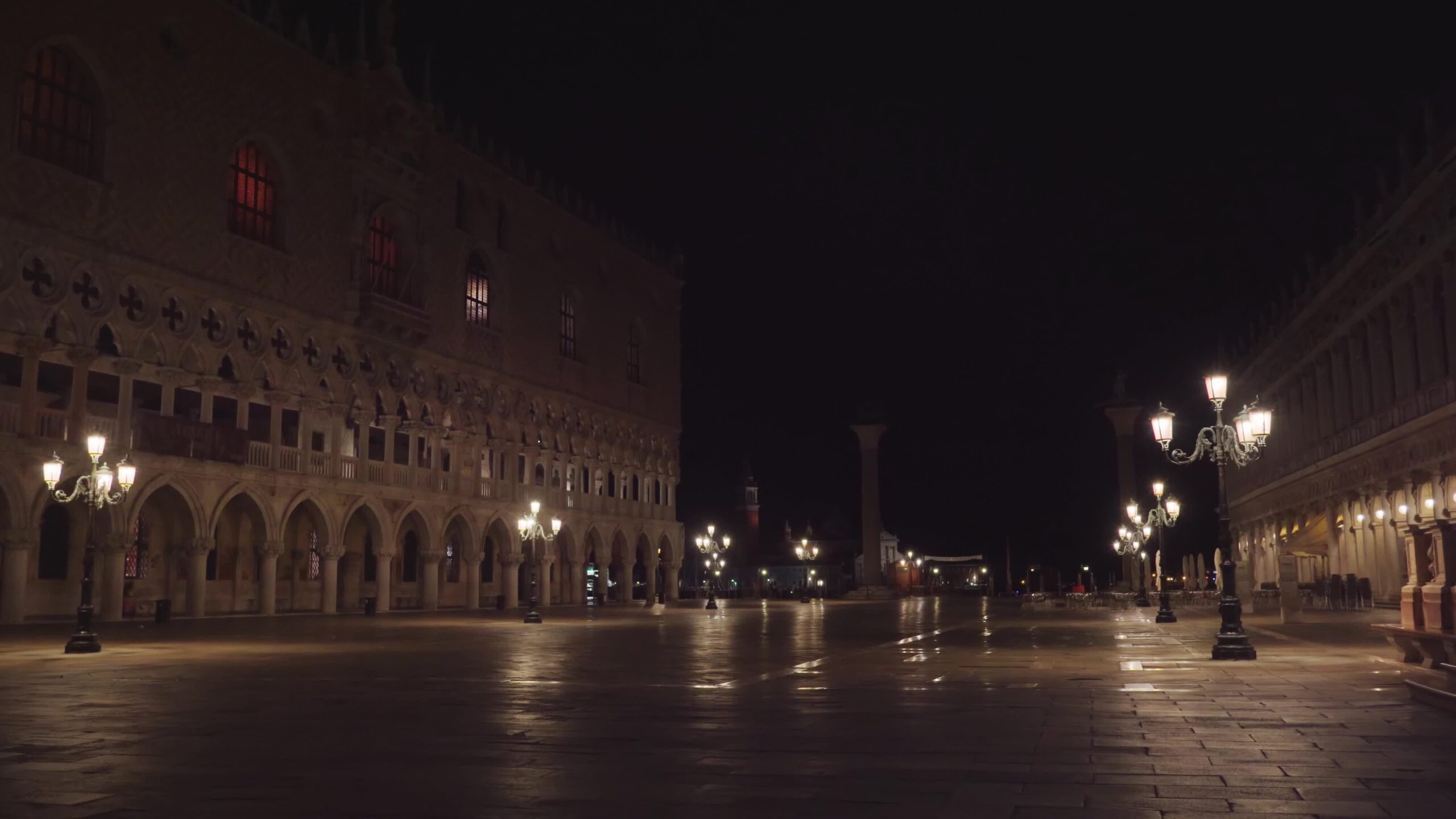 Empty Saint Mark Square with bright lanterns at night