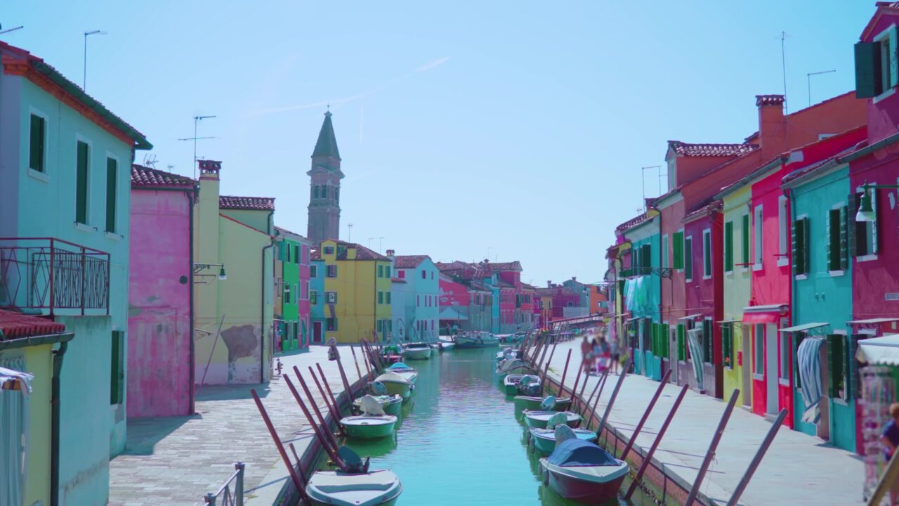 Bright colorful houses stand in row along water channel