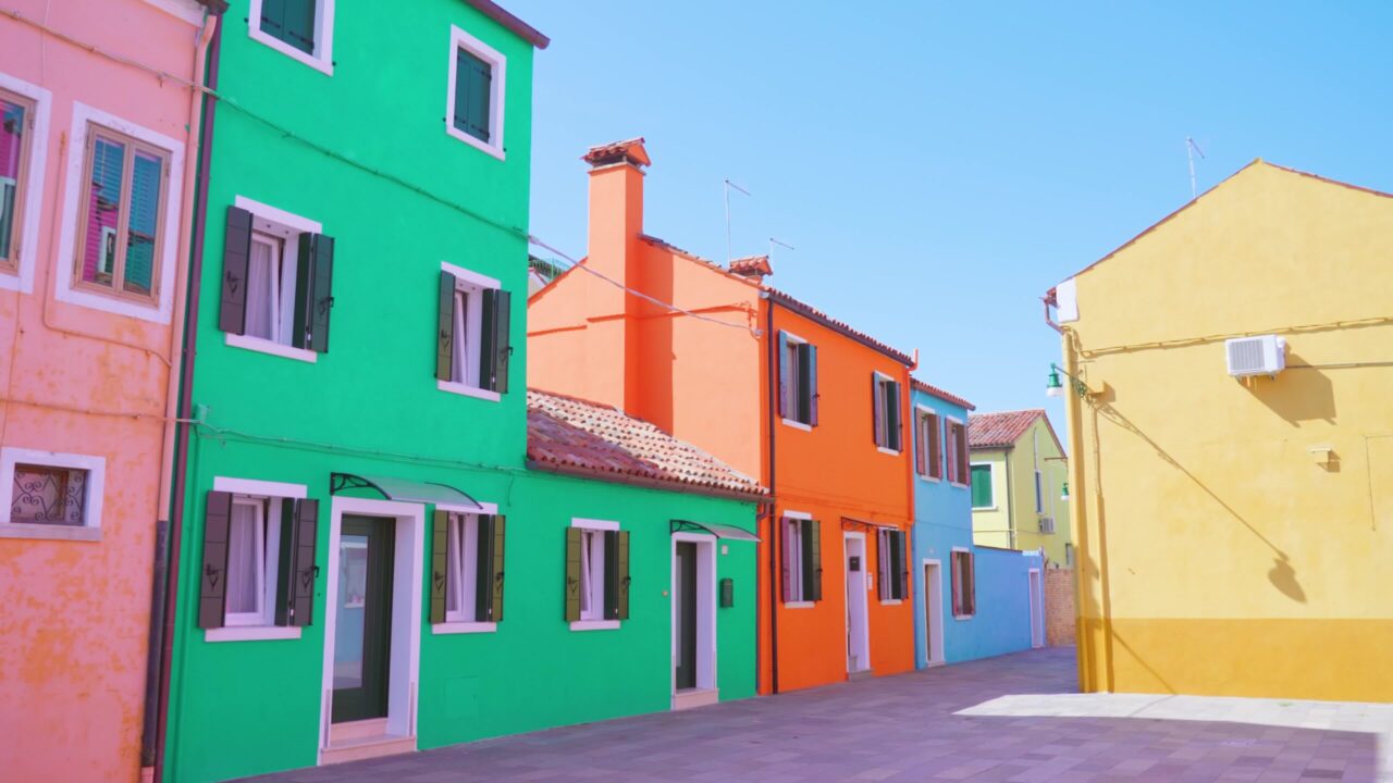 Quiet street of Burano with rows of multi-colored houses