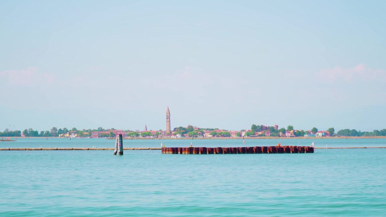 Cityscape of Burano island from boat on Venitian lagoon