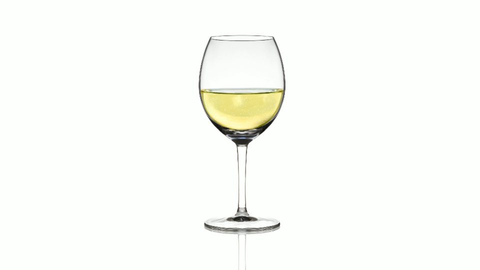 Empty glass filling with sparkling wine on white background
