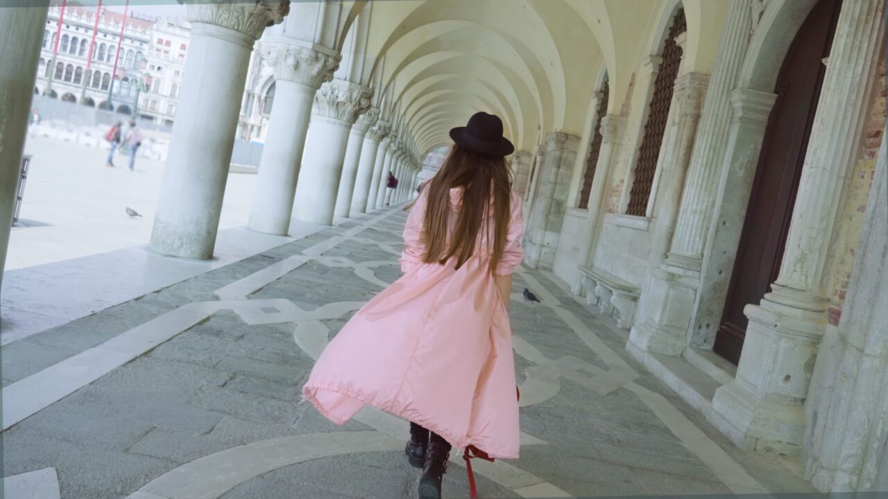 Woman walks in building with columns at St. Mark Square