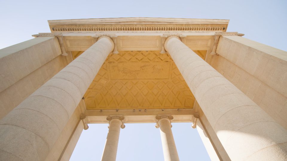 High columns of Porta Ticinese against clear blue sky