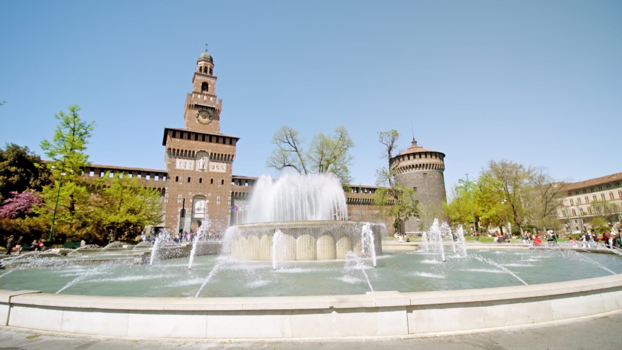 Tourists visit Fountain of Castle square on sunny day