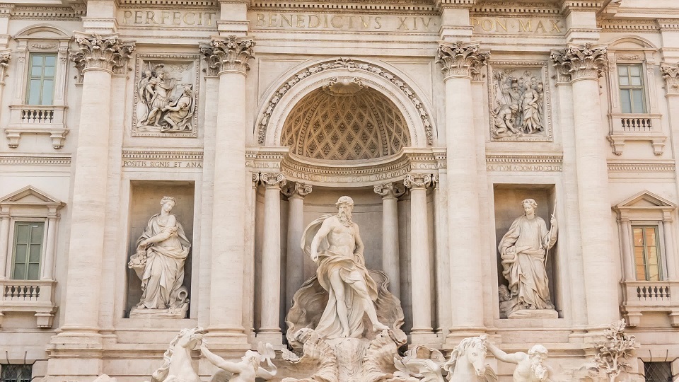 Trevi Fountain with white statues built in center of Rome