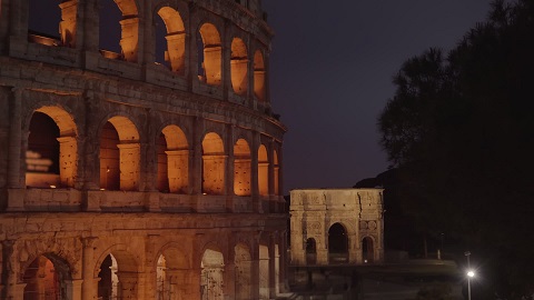 Triumphal arch built near Colosseum in old Rome at night