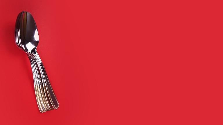 Spoons on red background