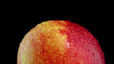 Rotation Around The Red And Yellow Apple On A Black Background