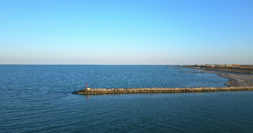 Seashore with a dam and many small stone and brick dams