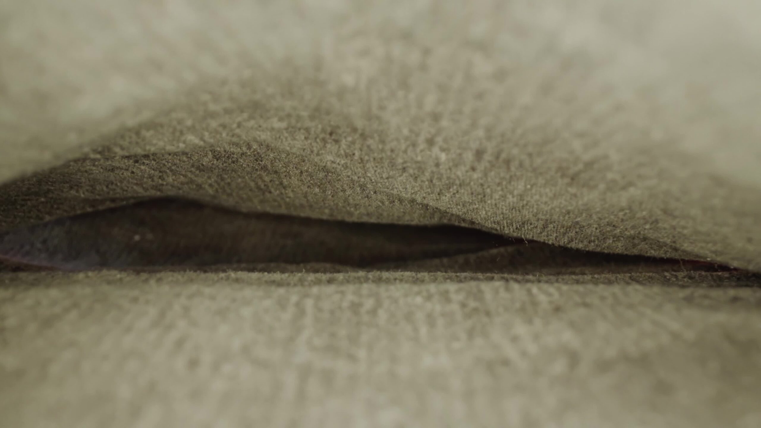 Folded dark denim pants leg inner side on table in studio