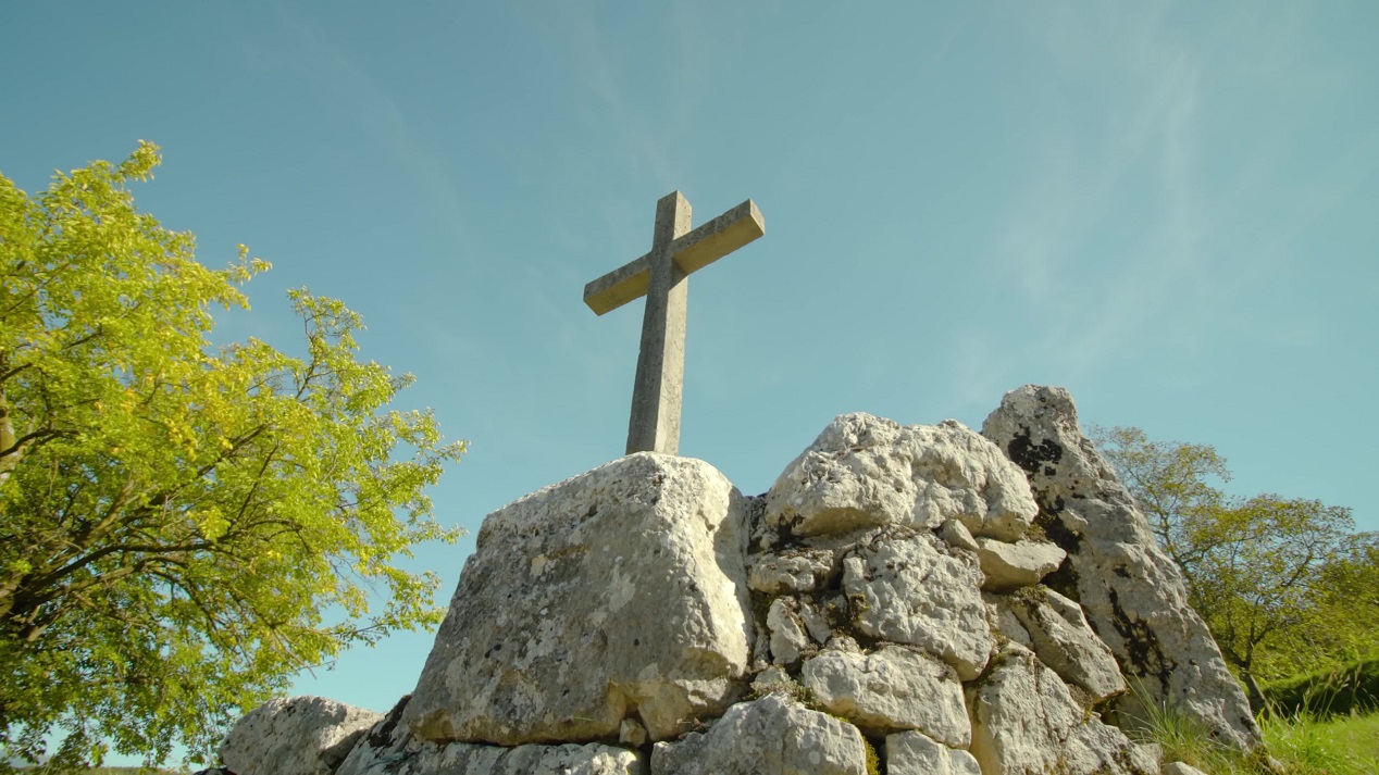 Pile of stones with lithic cross monument in national park