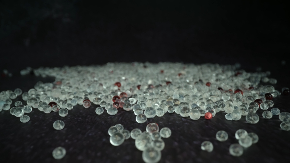 Motion above table with scattered beads on black background