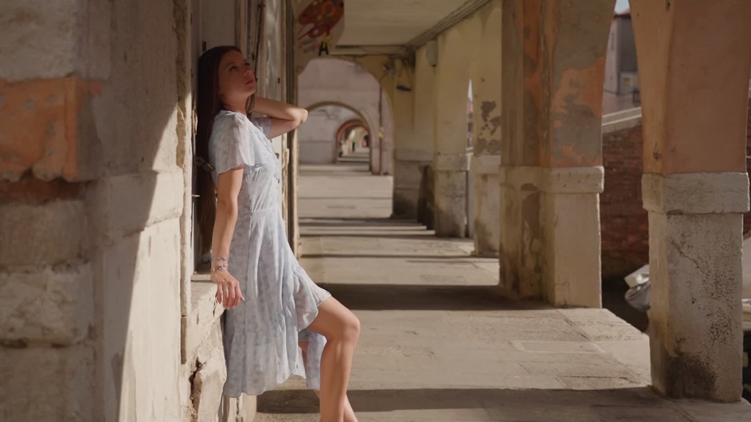 Young Woman in Venice: Sitting on the Wall of a House