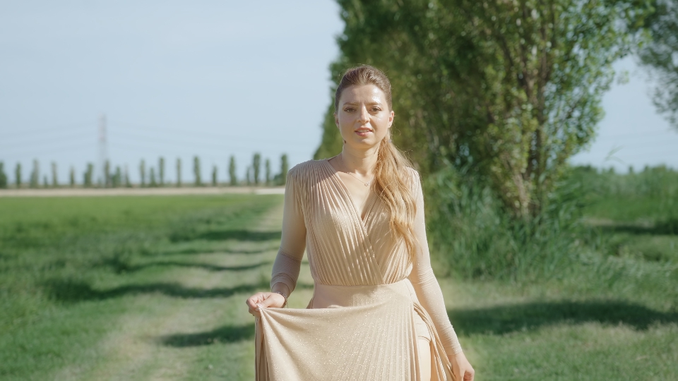 Natural Elegance: Young Woman in Elegant Dress Amidst Nature