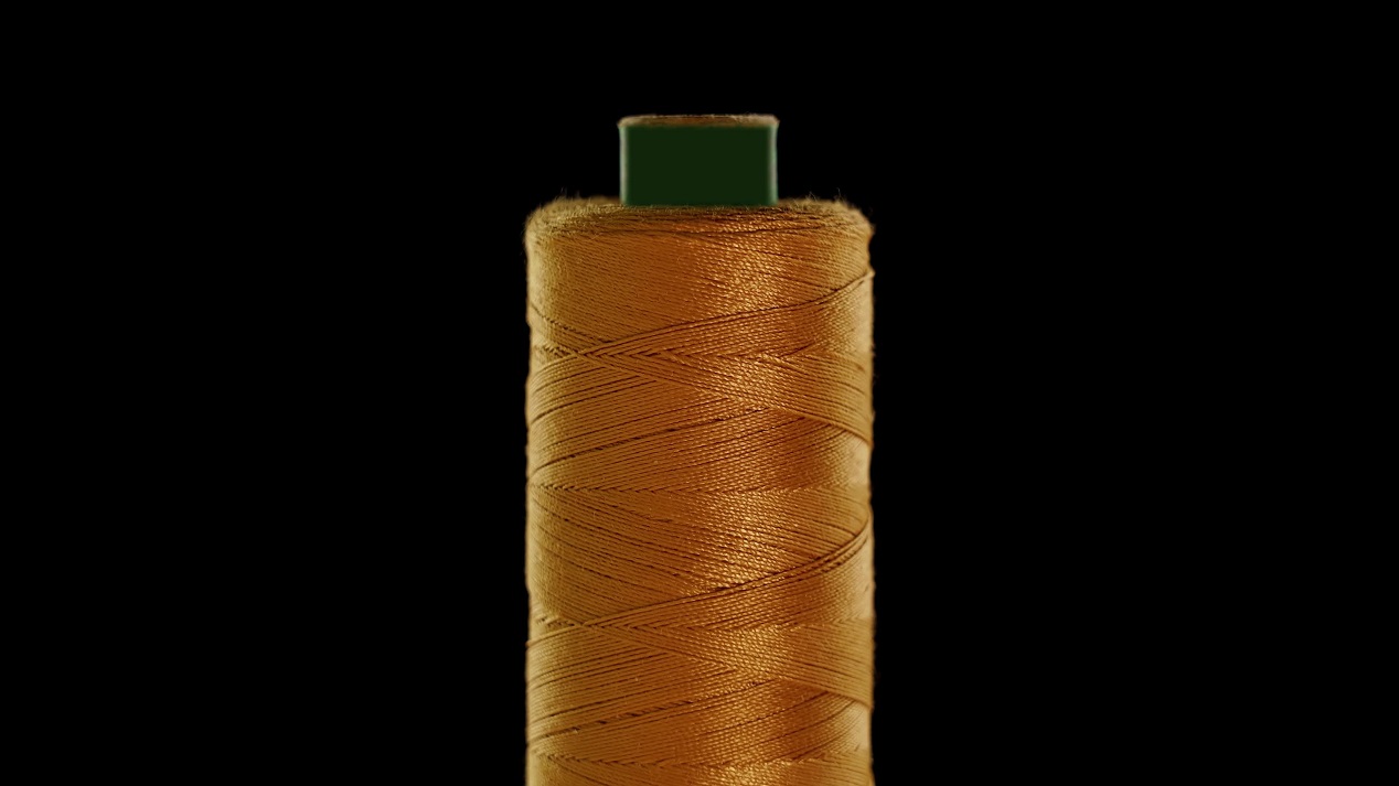 Filo per cucire color oro su sfondo nero