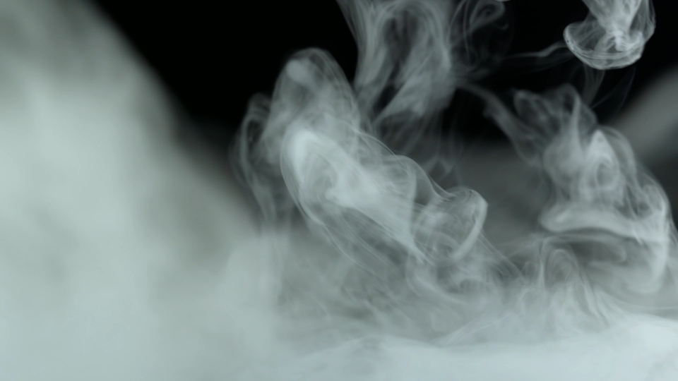 White smoke of electronic cigarette on black background