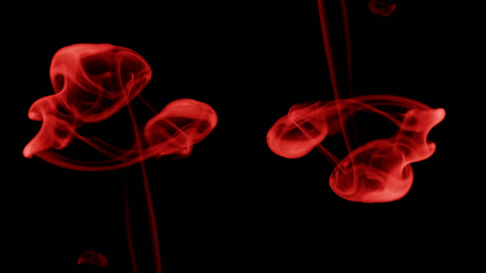 Red smoke on black background