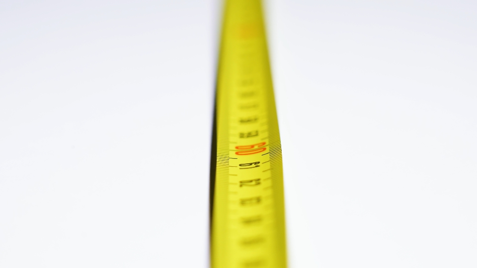 Yellow meter tape moves on white background