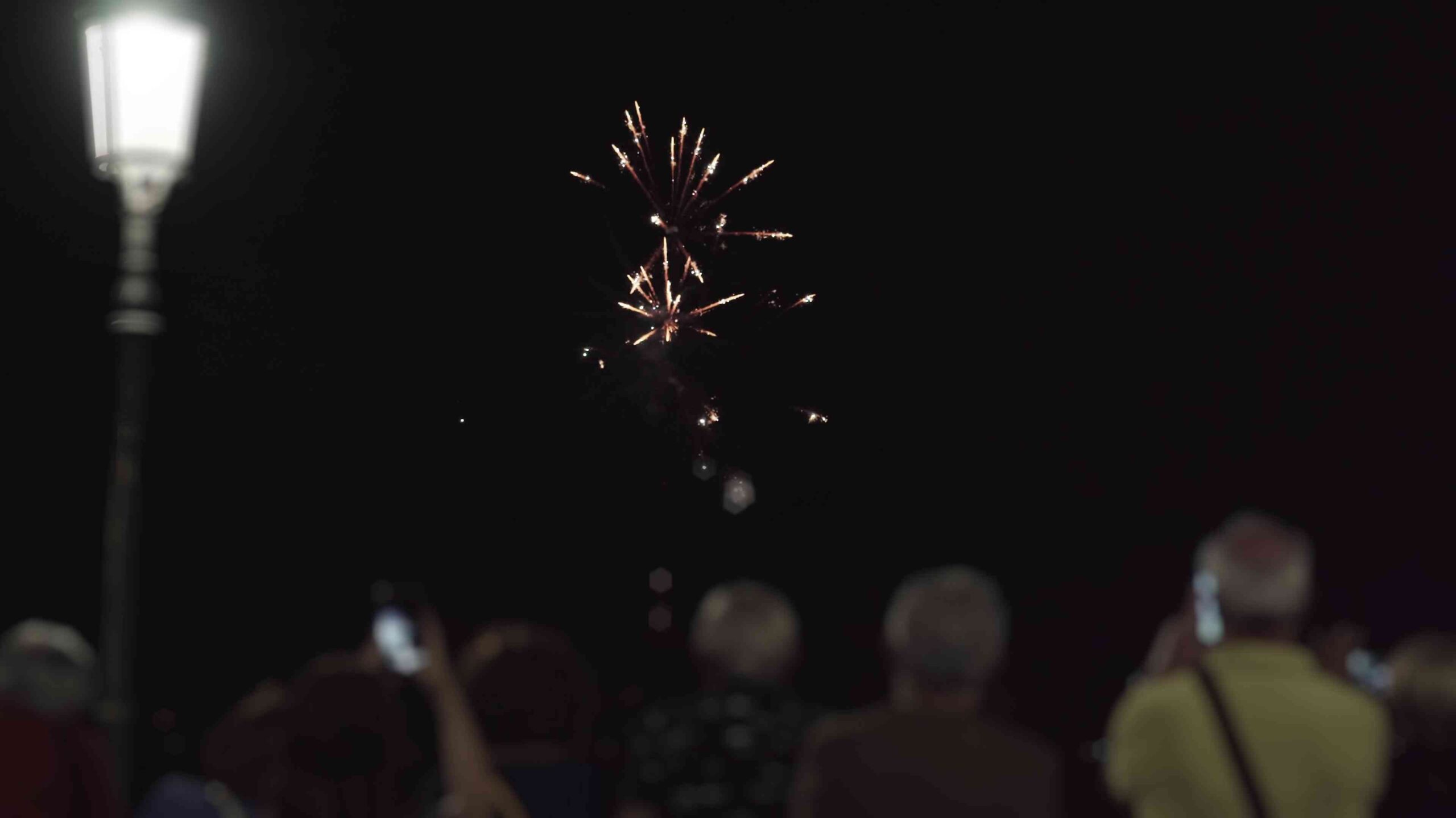 Fireworks explode quickly in front of people