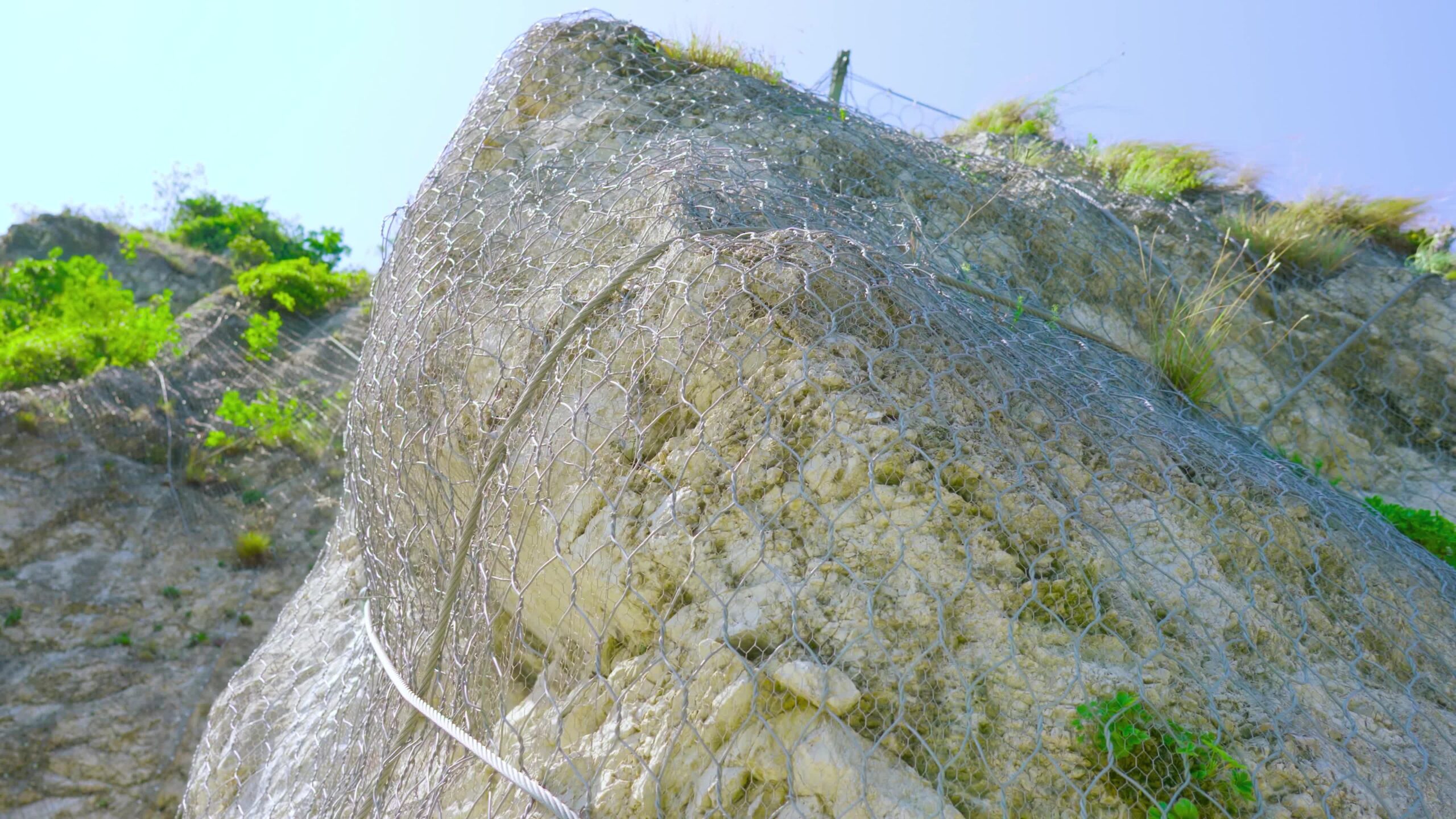 Protective net envelops the rocks of the mountain