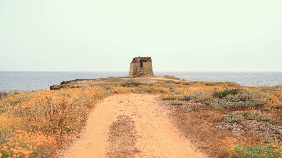 Island in the middle of the sea with ruined ancient lighthouse