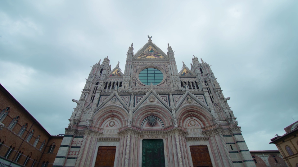 The gothic facade of the cathedral Duomo di Siena