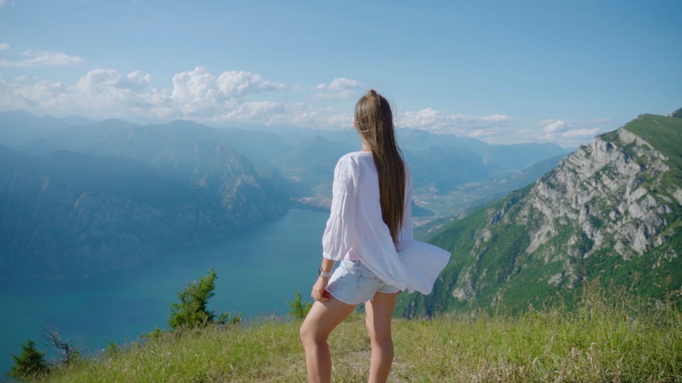 Tourist relaxes while observing beautiful landscape of mountains