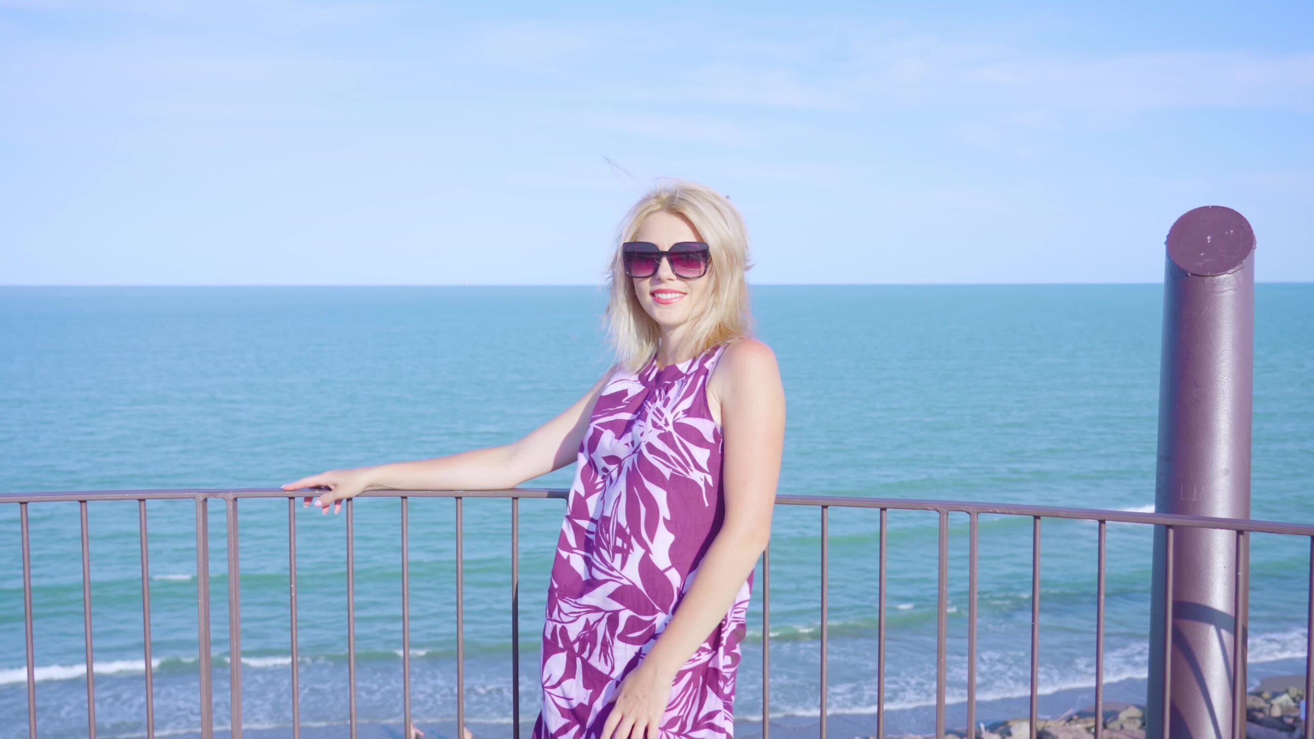 Donna su una torre di fronte al mare azzurro