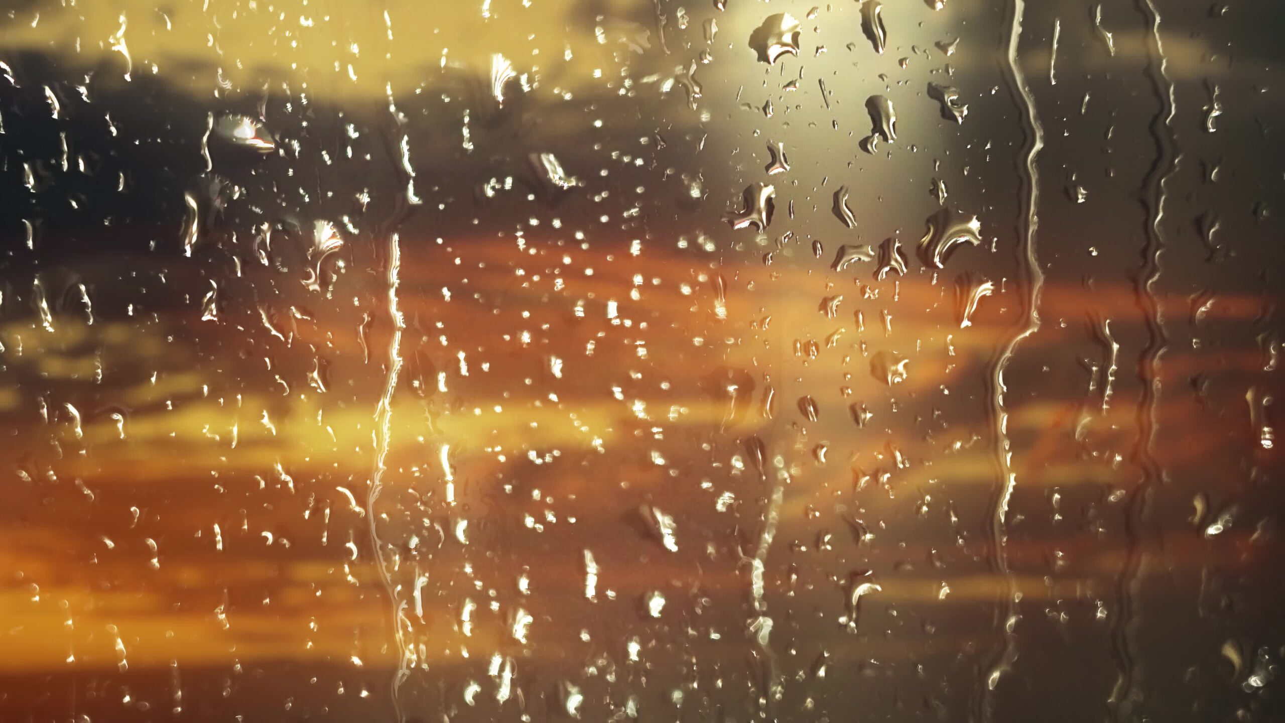 Rain on the window at the beautiful sunset