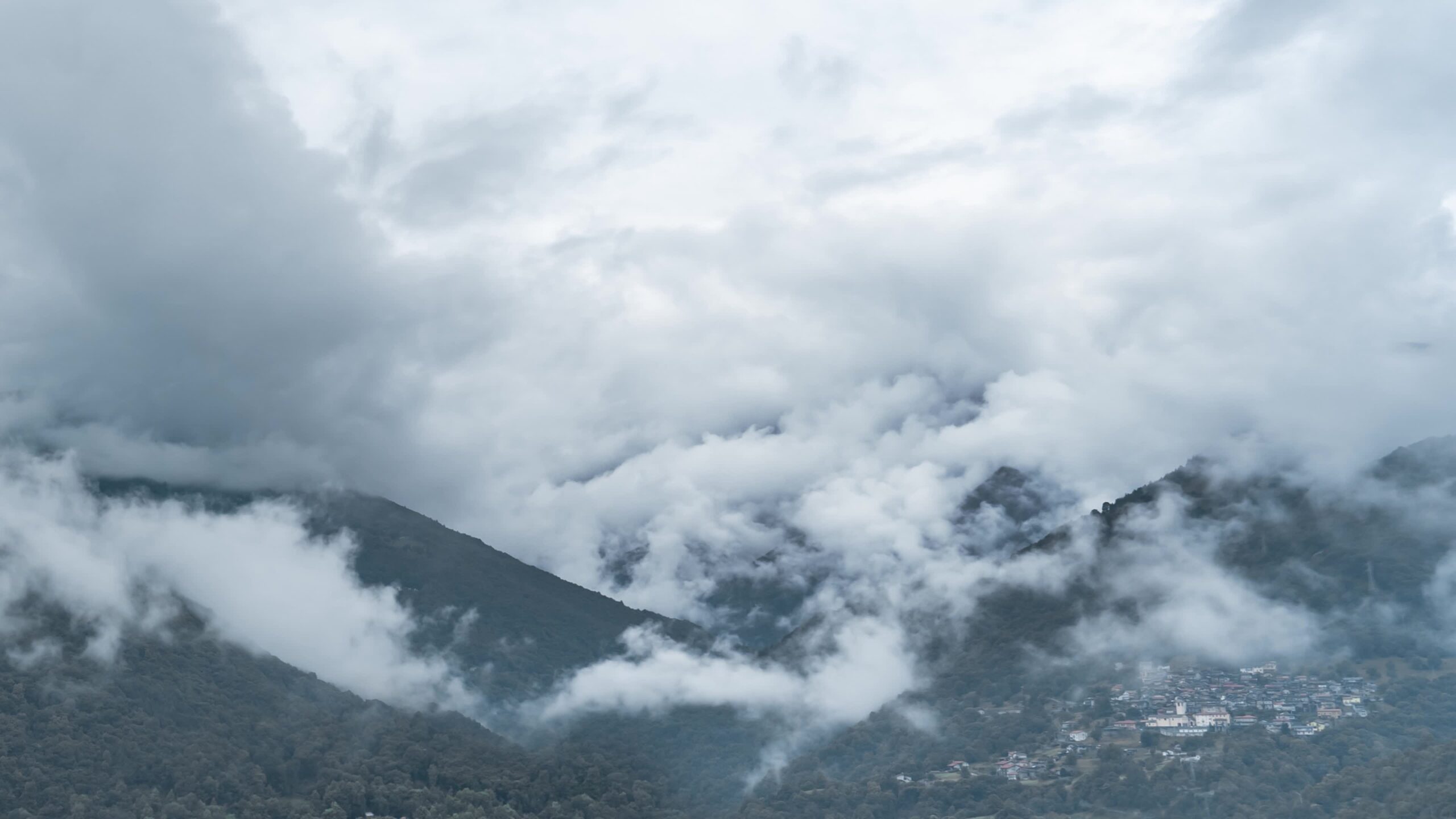 Clouds and fog move between the mountains