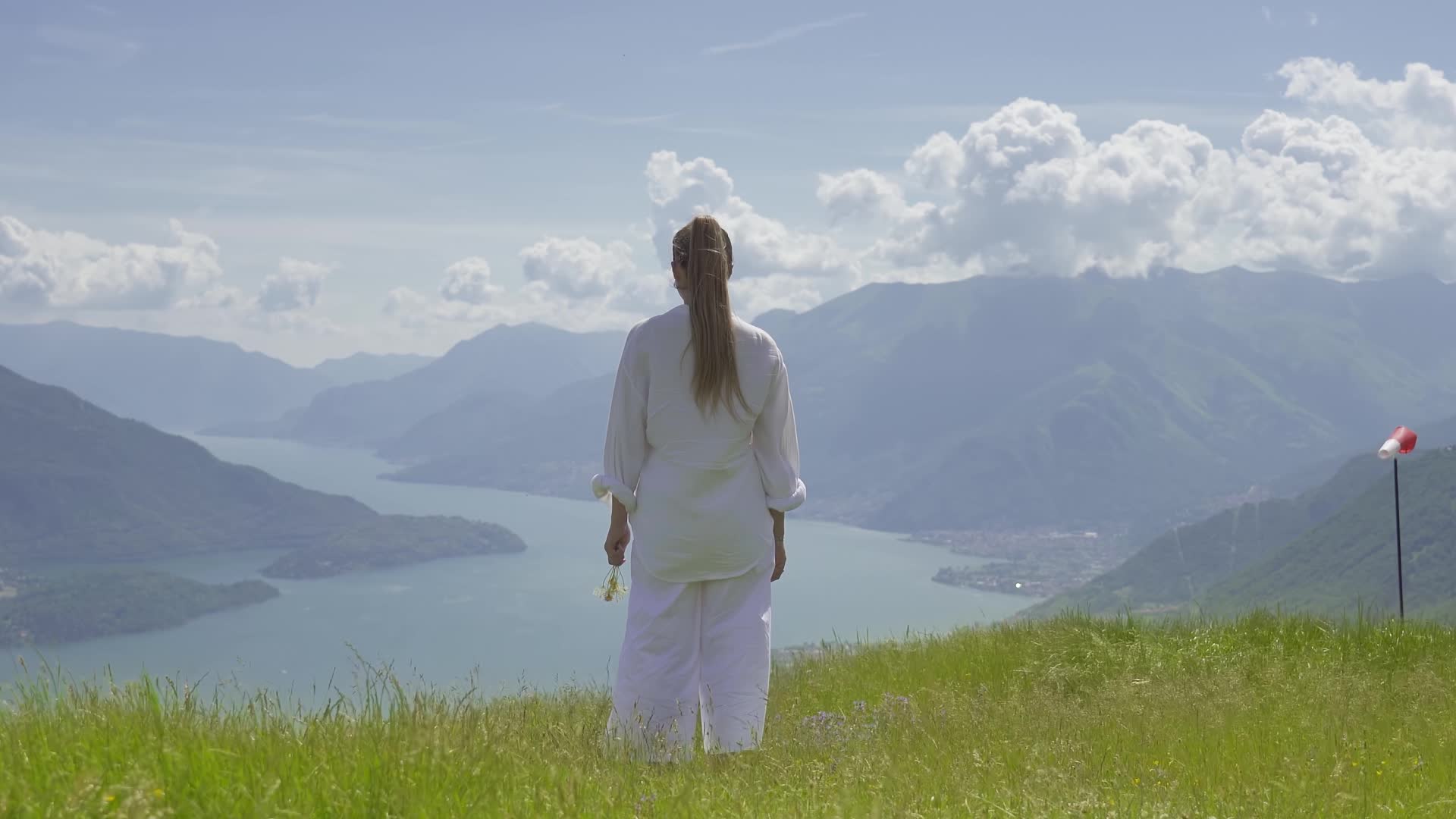 Lake Como is observed from above by a woman