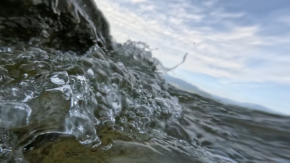 Seashore with waves and pebbles