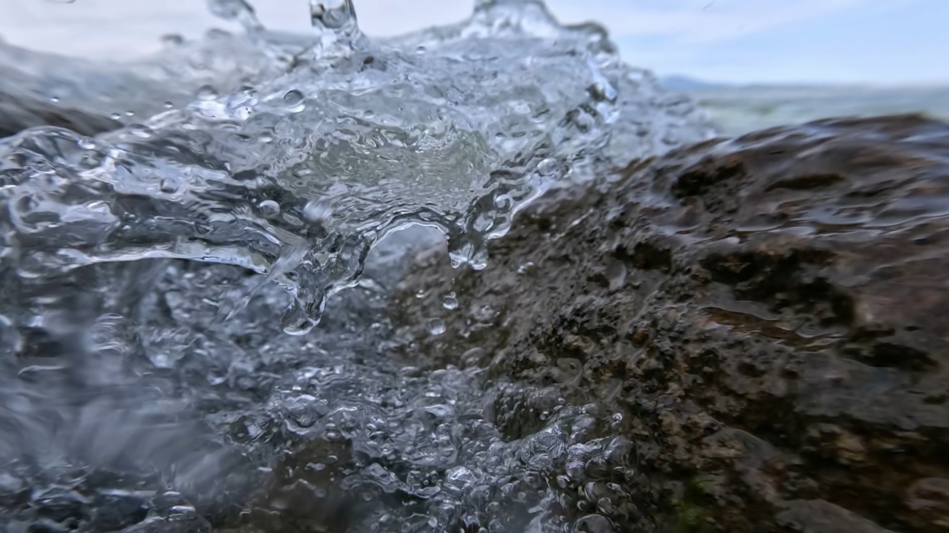 Splash of the waves between the rocks in slow motion