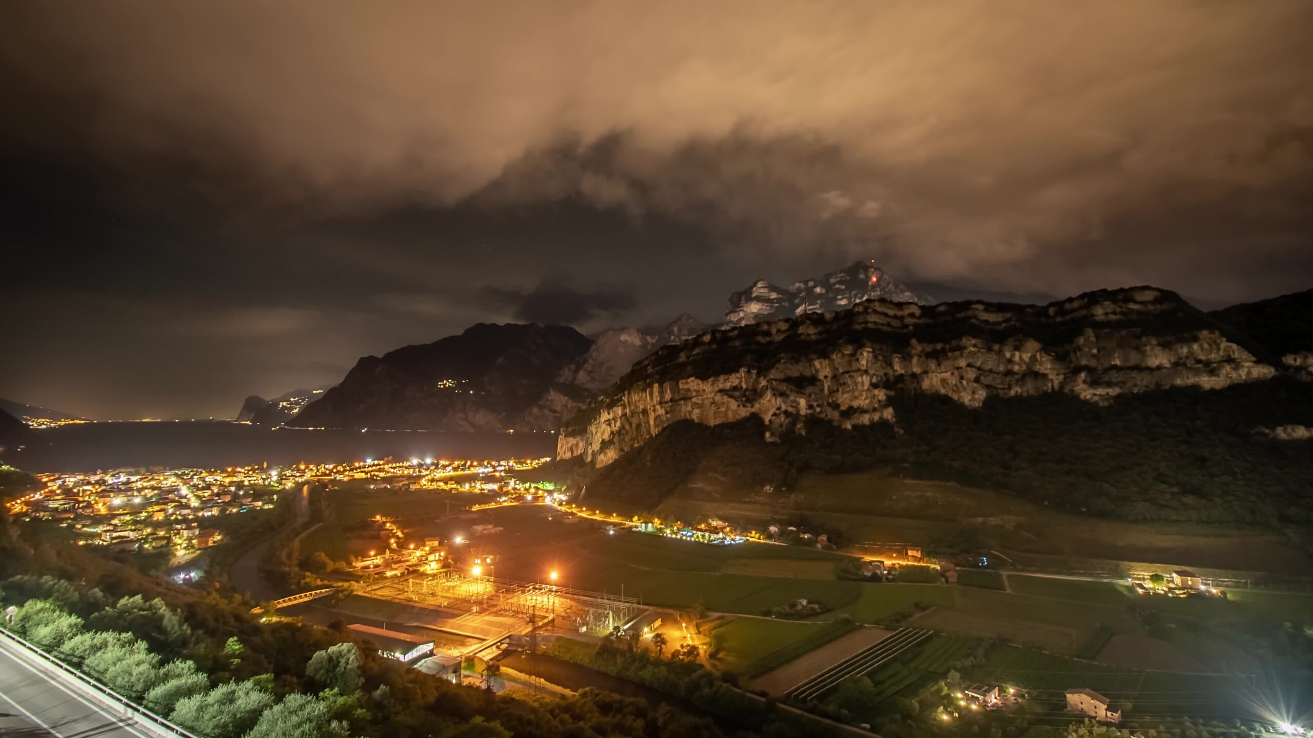 Night timelapse of the city in the mountains in Italy