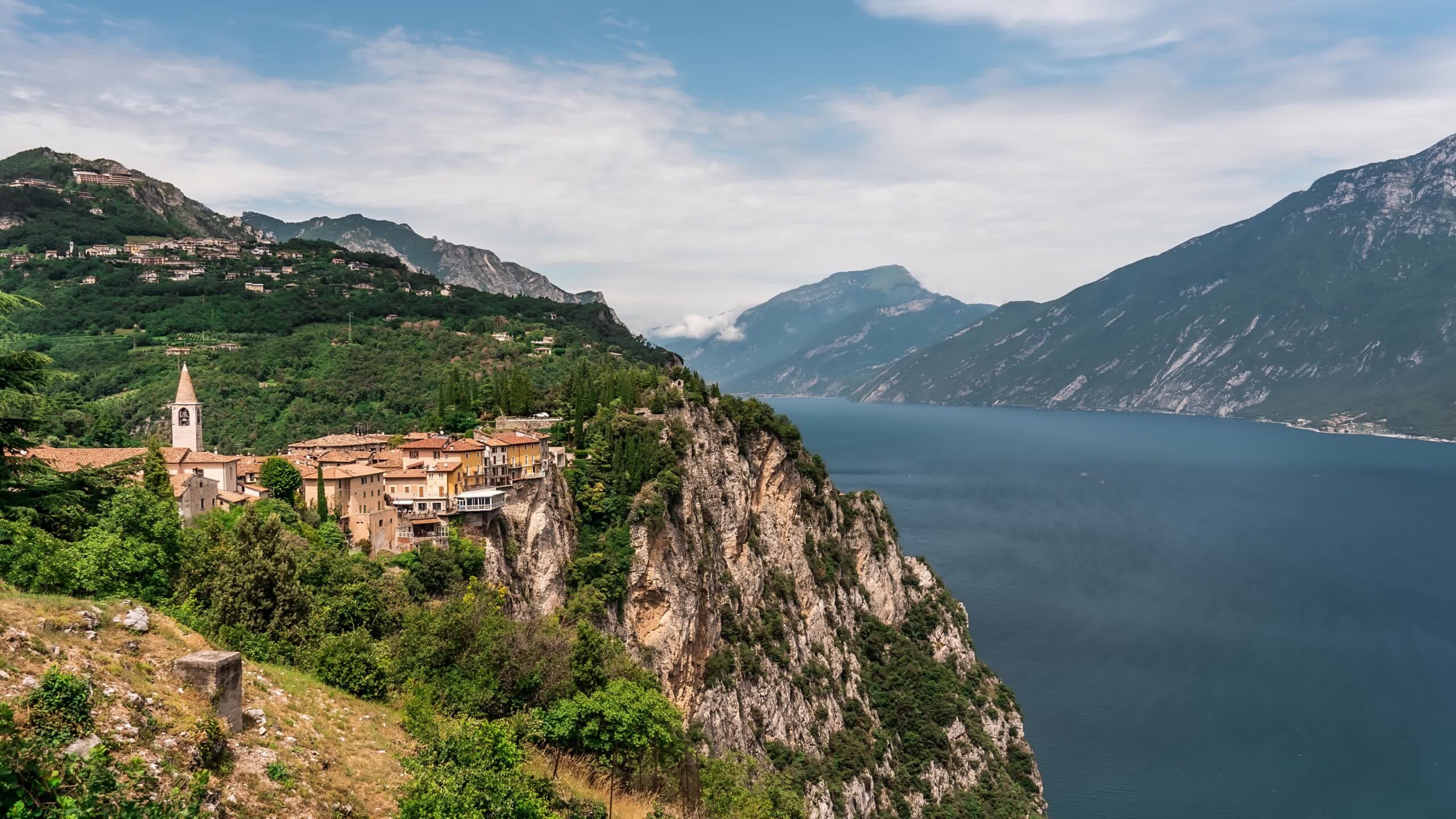 Buildings on the Rocky Mountains in front of a large lake