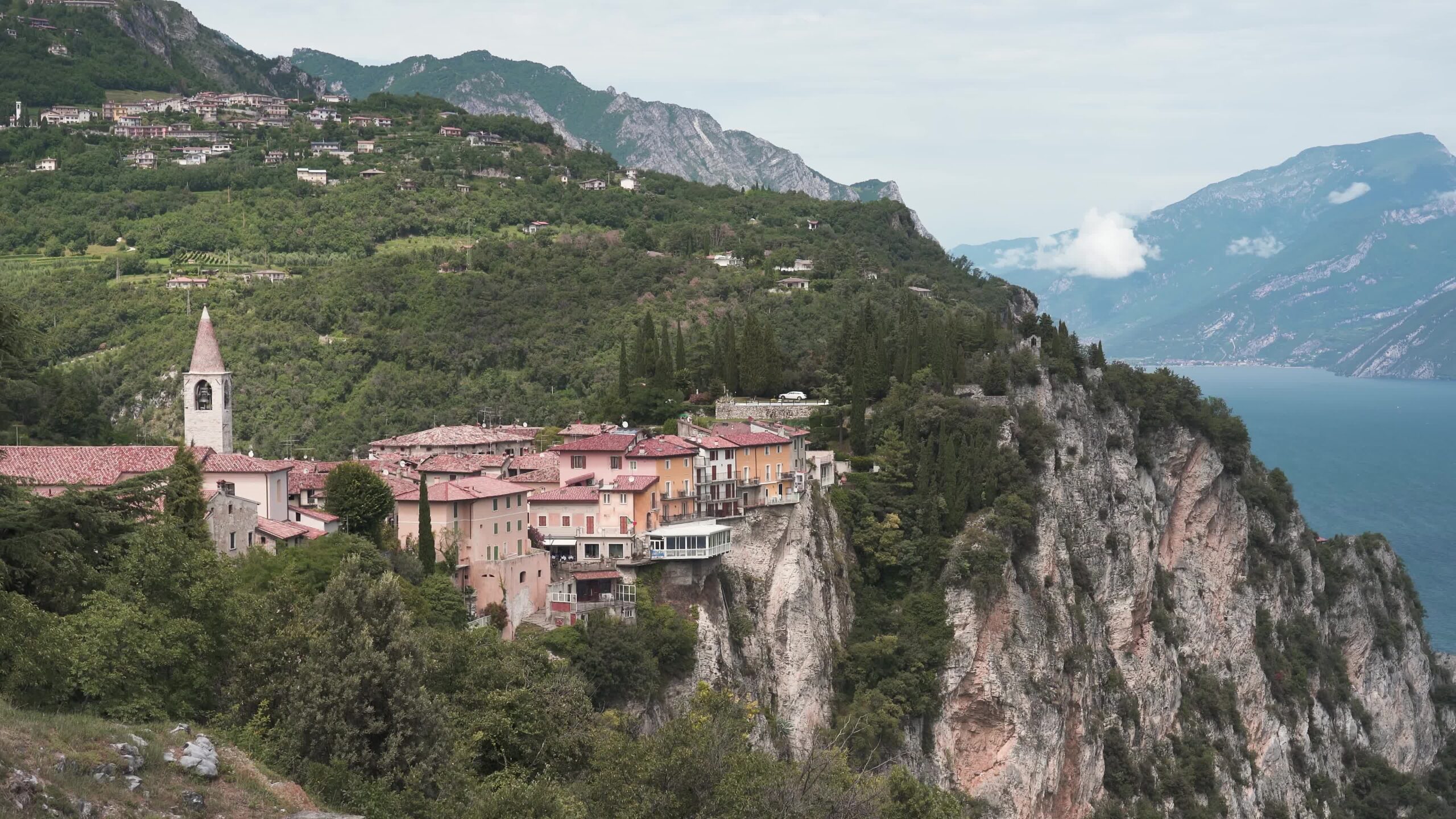 Houses hanging on rocks above high mountains