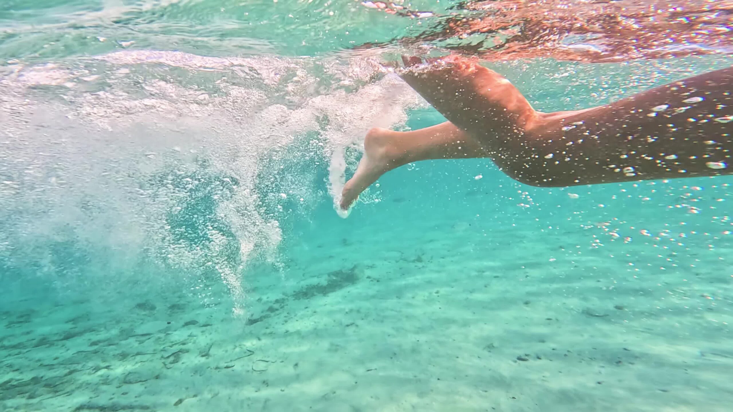 Gambe che nuotano nel mare