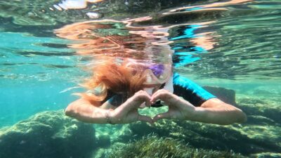 Heart sign with hands underwater