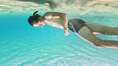 Man floats underwater in the sea