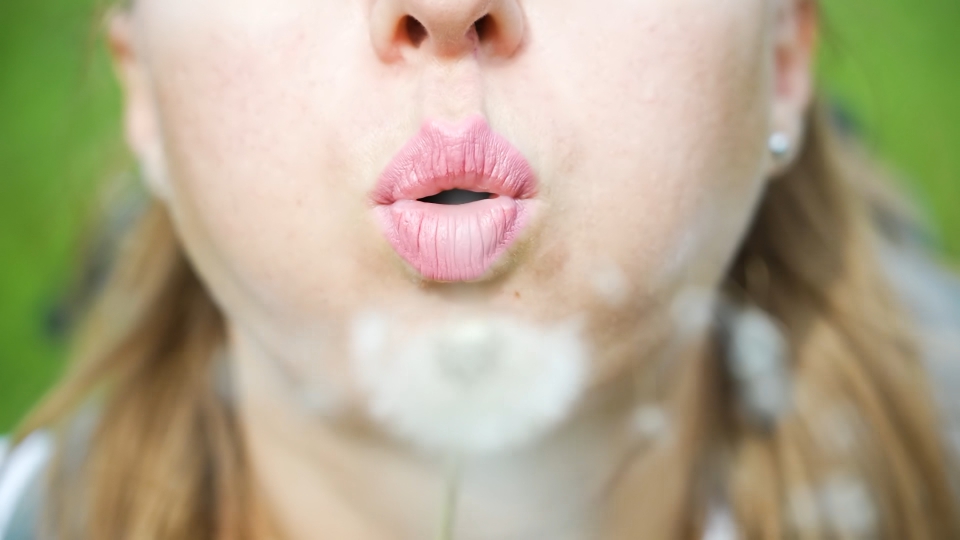 Woman’s lips blow shower head