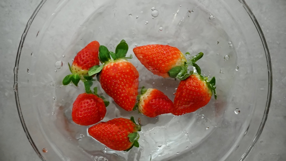 Red Strawberries in a Dish with Water – Top-Down Shot